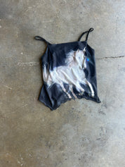 Black mesh tank with a white unicorn on the front on a concrete surface