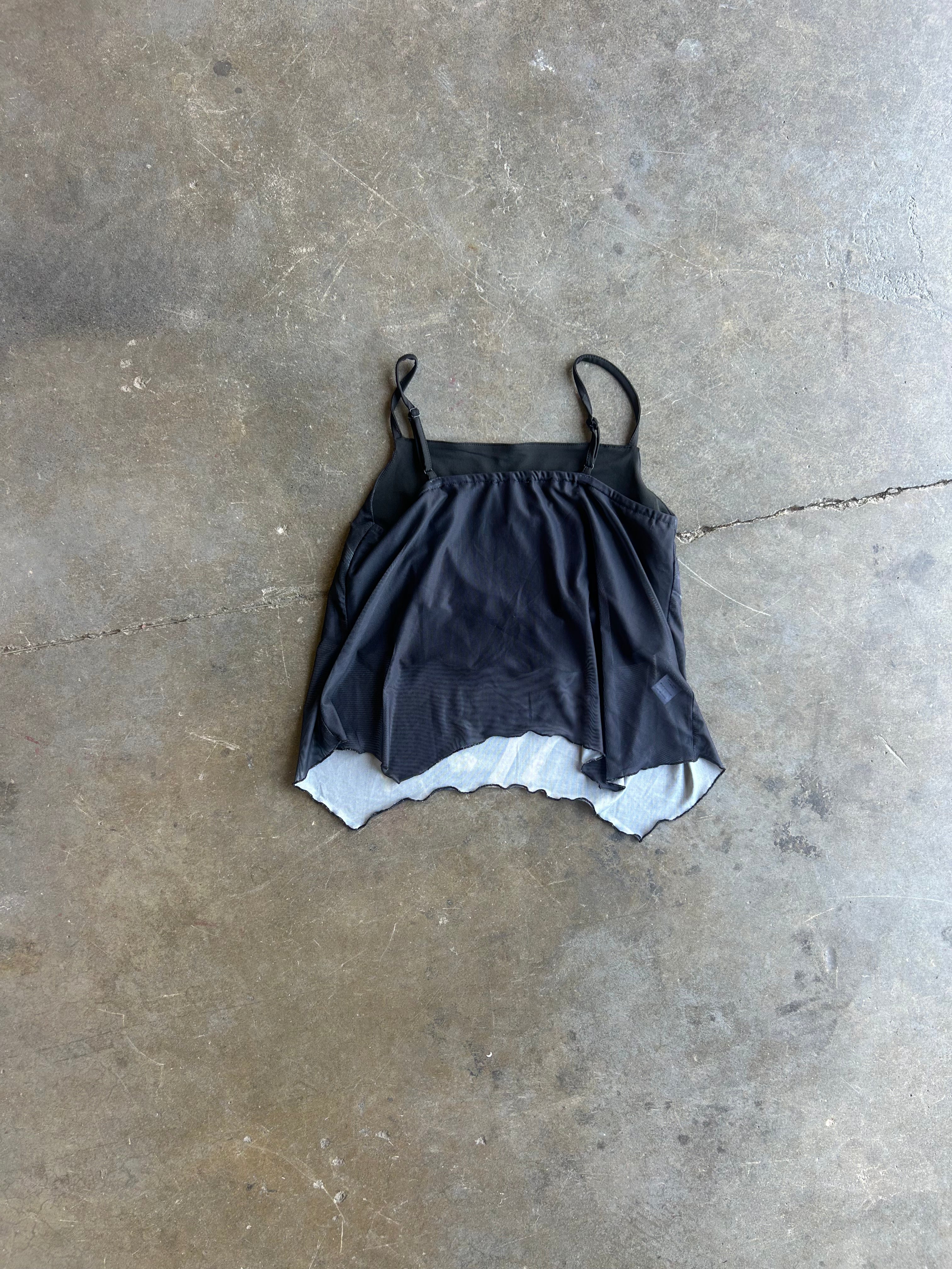 backside of black mesh tank on a concrete surface