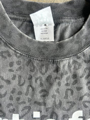Close up of XL tag on collar of graphic tee