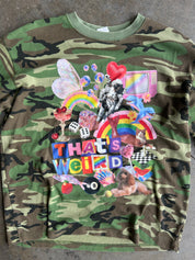 Close up of a long sleeve camo waffle tee with a collage on the front with the text That's Weird, flat lay frontal view on a concrete surface