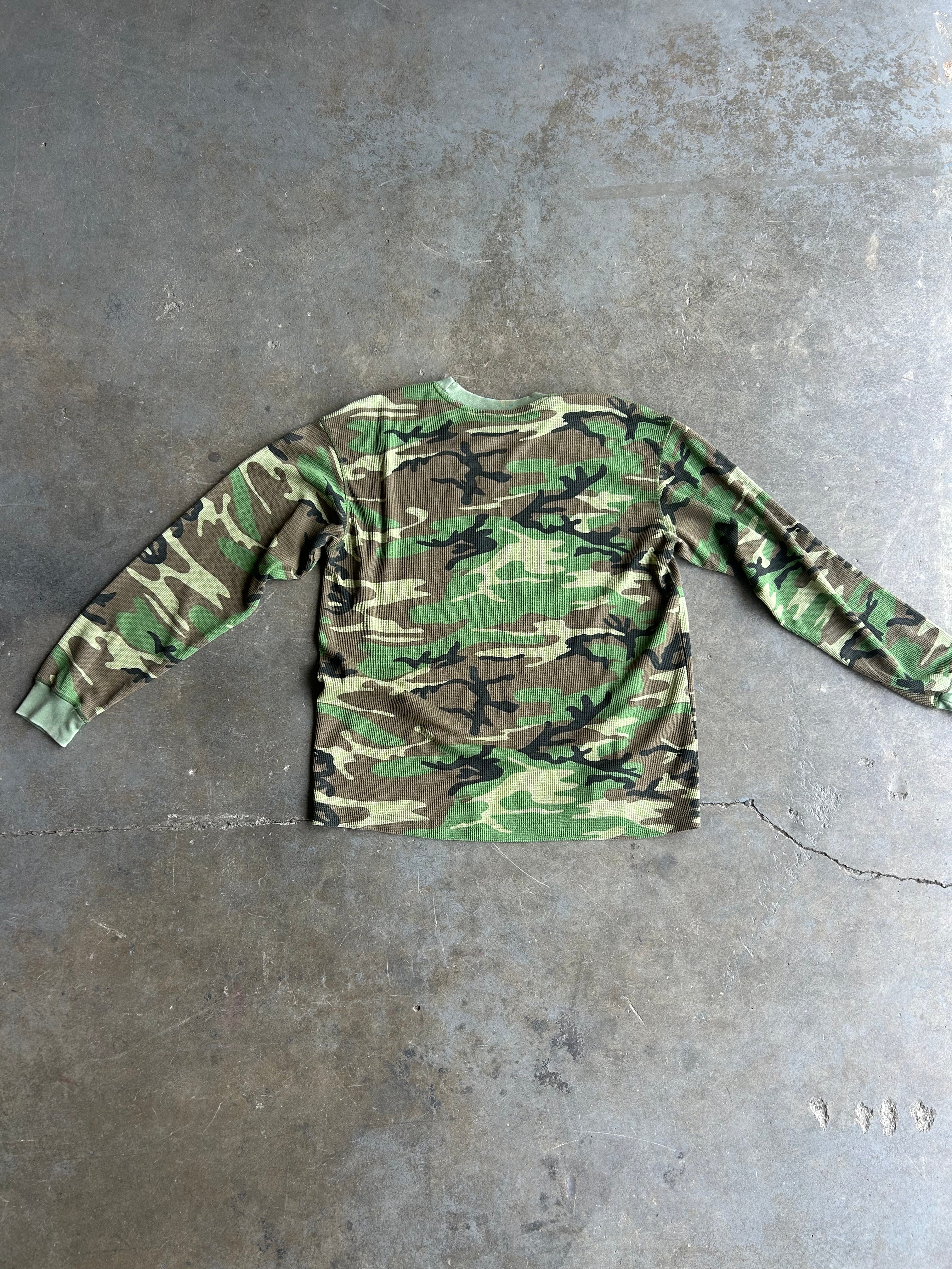 Long sleeve camo waffle tee, flat lay back view on a concrete surface