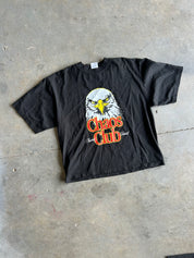 Black tee with eagle graphic and Chaos Club text on a concrete surface