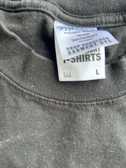 Close-up of a dark gray t-shirt neck collar showing the inner care label which reads 'Streetwear Selection' and 'Drop Shoulder Garment Dye'.
