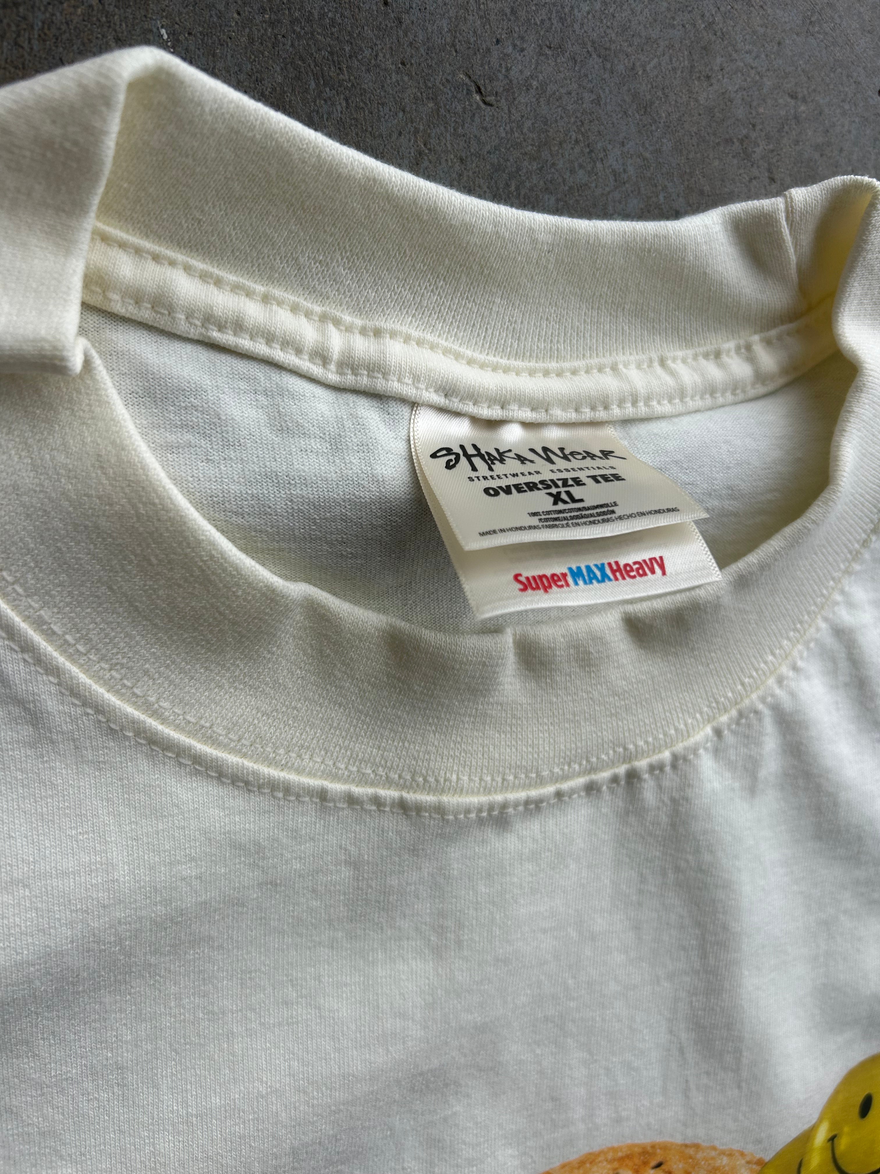 Close-up of the neck area of a cream-colored t-shirt, showing the inner collar label which reads 'Hyper Heavy' and 'Super MAX Heavy'.