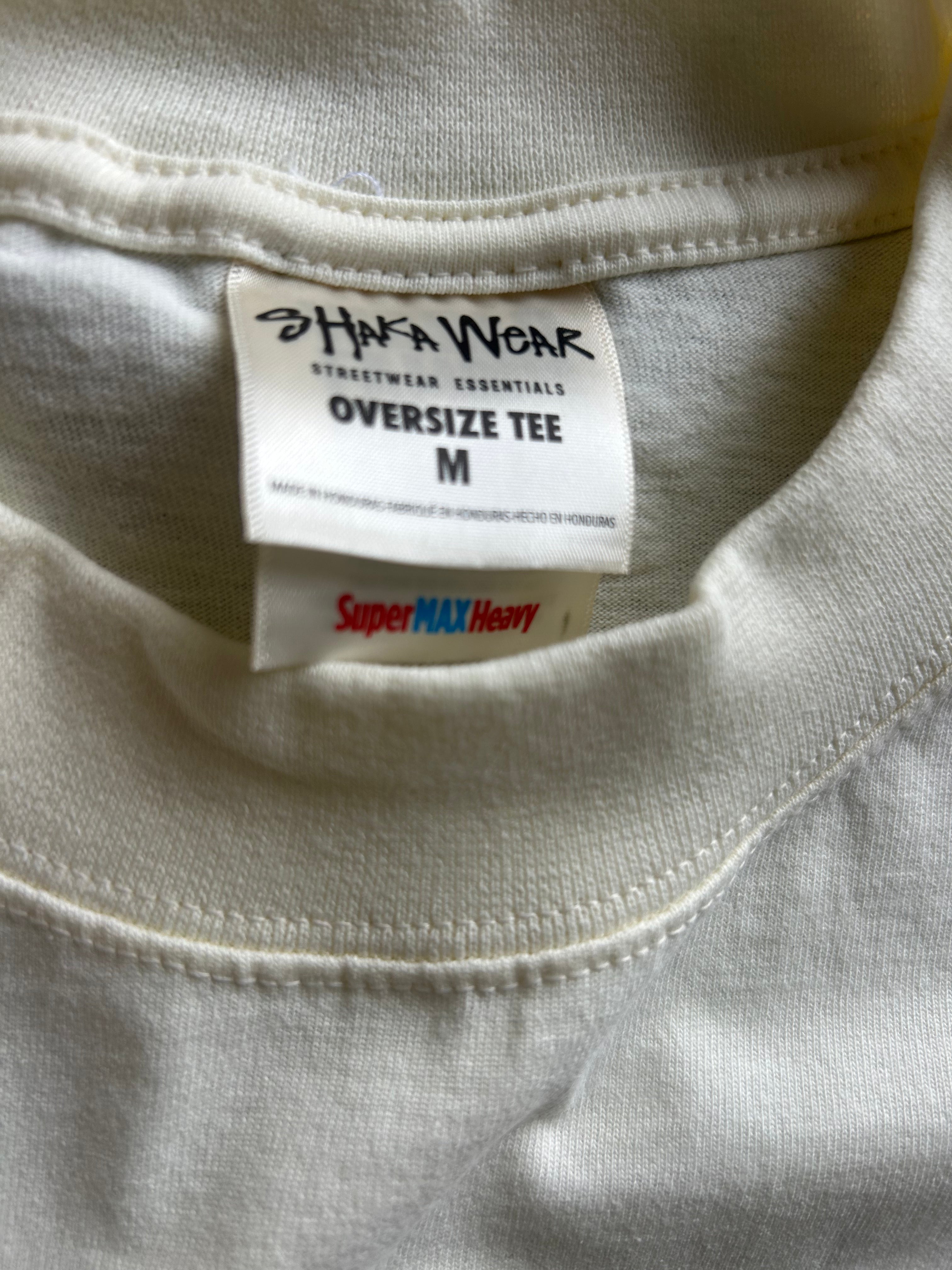 Close-up of a cream-colored oversized t-shirt showing the inner neck label which reads 'Hafa Wear Streetwear Essentials Oversize Tee M' and a 'SuperMAX Heavy' tag.