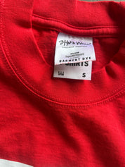 Close-up of a red crewneck t-shirt showing the inner neck label which reads 'SHWW Apparel' and 'Garment Dye'.