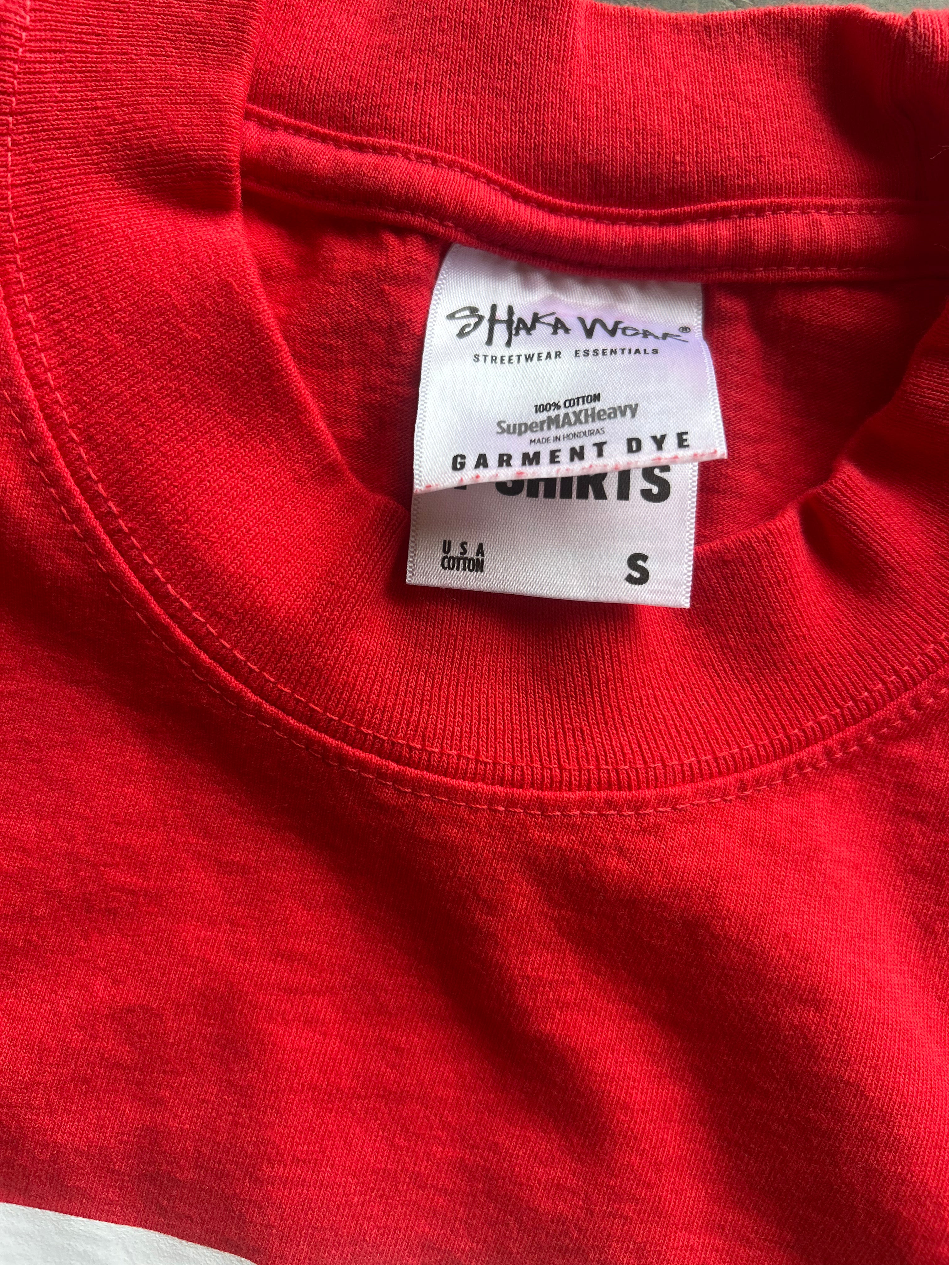 Close-up of a red crewneck t-shirt showing the inner neck label which reads 'SHWW Apparel' and 'Garment Dye'.