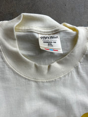 Close-up of the inside collar of an off-white oversized t-shirt, showing the brand label 'John Wick' and size '2XL'.
