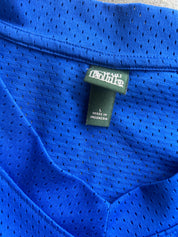 Close-up of a bright blue mesh athletic shirt showing the inner neck label with 'Fab' branding and 'MADE IN INDONESIA' text