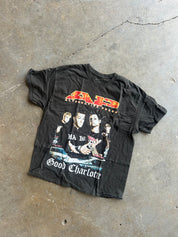 Graphic tee with Good Charlotte text and picture of band on a concrete surface