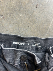 Close-up of the waistband of Old Navy high-rise baggy short jeans in a washed black denim, showing the brand name and size details on the inner label