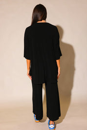 Back view of model wearing the Back in Black pant and short sleeve set, highlighting the fit and length of the pants and top