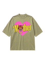 An oversized short-sleeve t-shirt in a heathered olive green, featuring a graphic print of a pink heart and the word 'Mother' in yellow with a tiger face in the center.