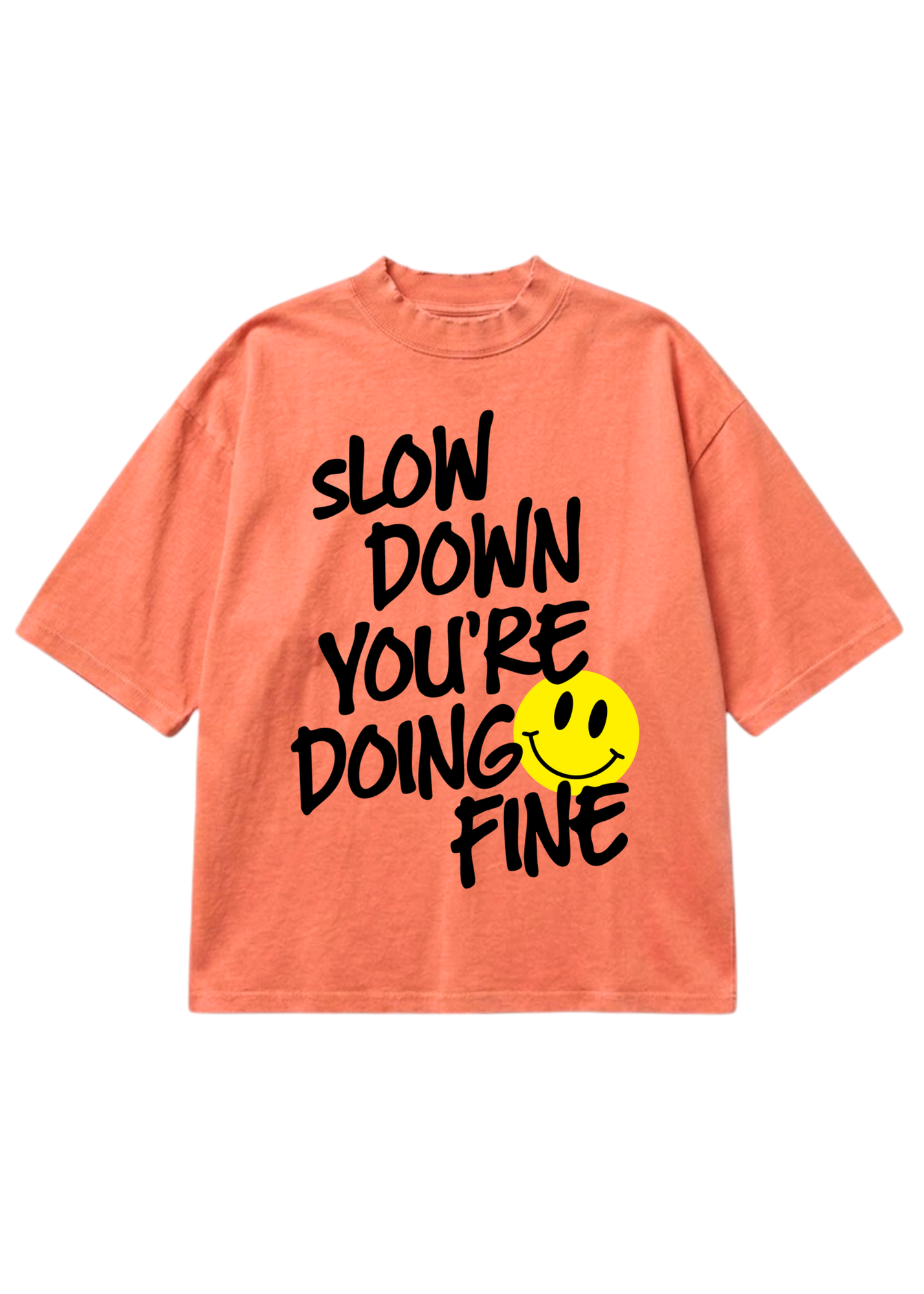 A coral pink short-sleeve t-shirt with a black hand-drawn text graphic reading 'SLOW DOWN YOU'RE DOING FINE' and a yellow smiley face, shown on a plain white background