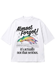 A white short-sleeve t-shirt with a graphic print featuring two colorful dolphins, a small planet, and the text 'Almost Forgot! it's actually not that serious.' on a plain white background