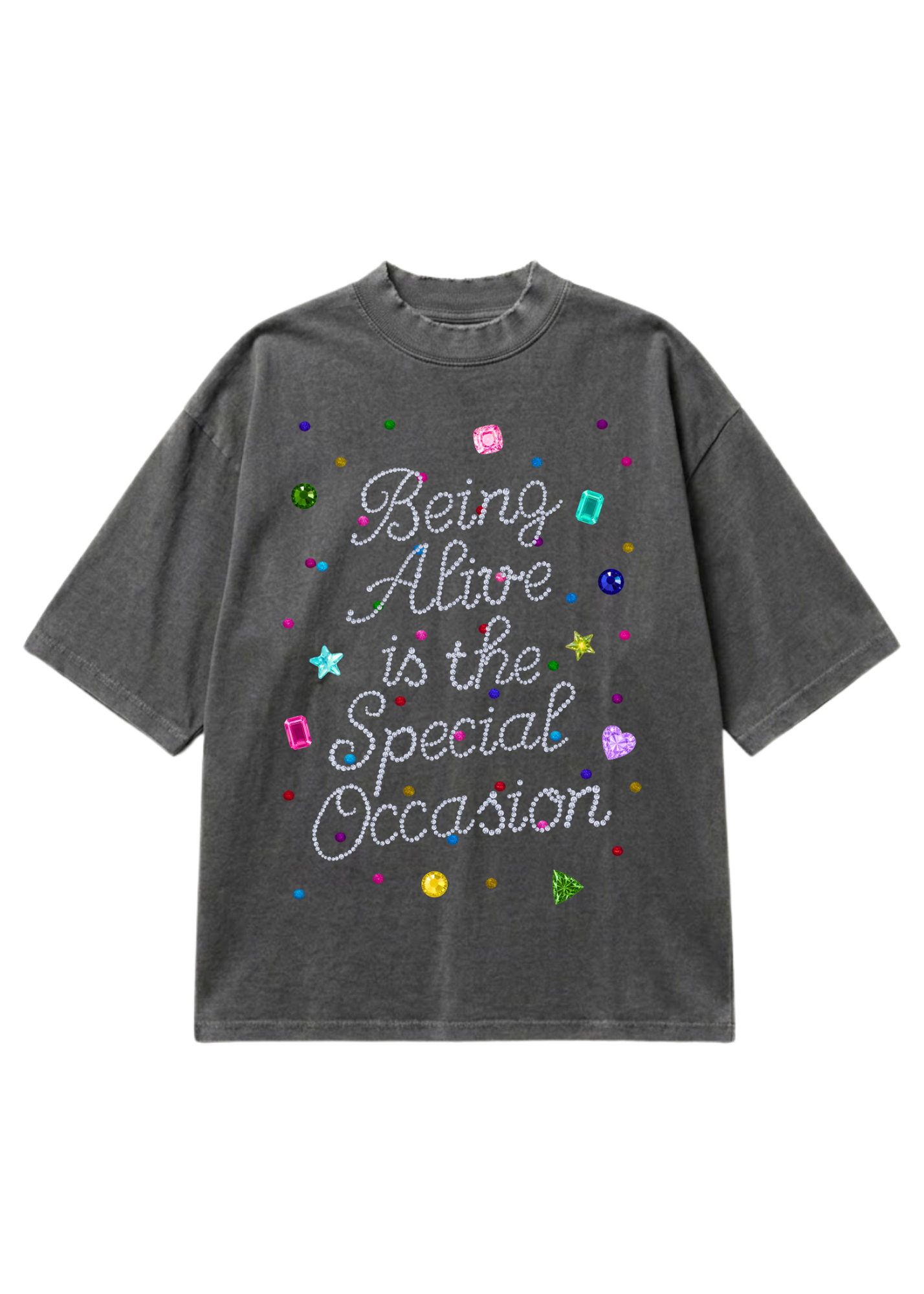 A dark gray washed t-shirt featuring the phrase 'Being Alive is the Special Occasion' in white cursive text, decorated with colorful glitter-style stars, hearts, and shapes on a plain white background