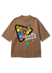 A brown short-sleeve t-shirt with a graphic on the front showing a pool billiard triangle filled with colorful fruit and billiard balls, with the text 'pretty please' in white script, flat lay frontal view