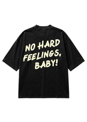 A black short-sleeve t-shirt with the phrase 'NO HARD FEELINGS, BABY!' printed in a bold, cream-colored retro font on the back, displayed against a solid white background