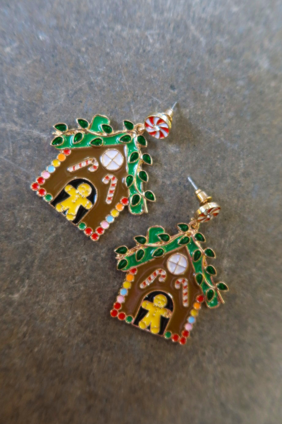 Pair of gingerbread earrings on a dark surface