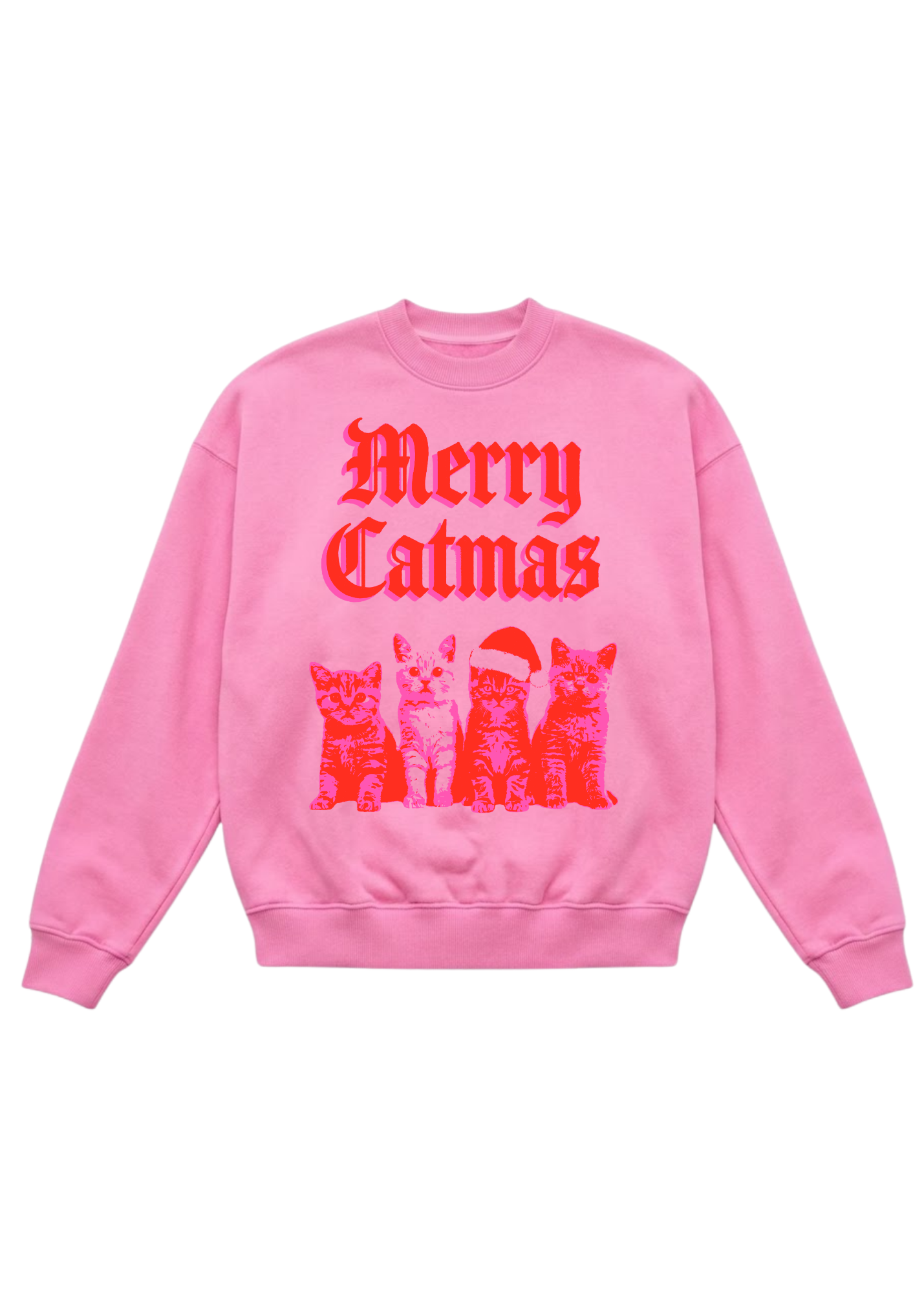 A pink oversized crewneck sweatshirt featuring “Merry Catmas” in bold red old English lettering above a graphic of four illustrated kittens — one wearing a red Santa hat — printed in red on the pink base. Flat lay on white background.