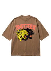 A brown short sleeve shirts with MOTHER in pink and a graphic of a cheetah and a leopard on a white background