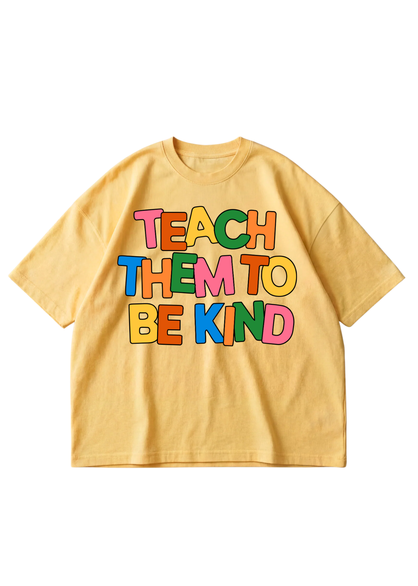 A yellow short-sleeve t-shirt with a colorful retro-style graphic on the front that reads 'TEACH THEM TO BE KIND' in multicolored letters, displayed flat against a white background