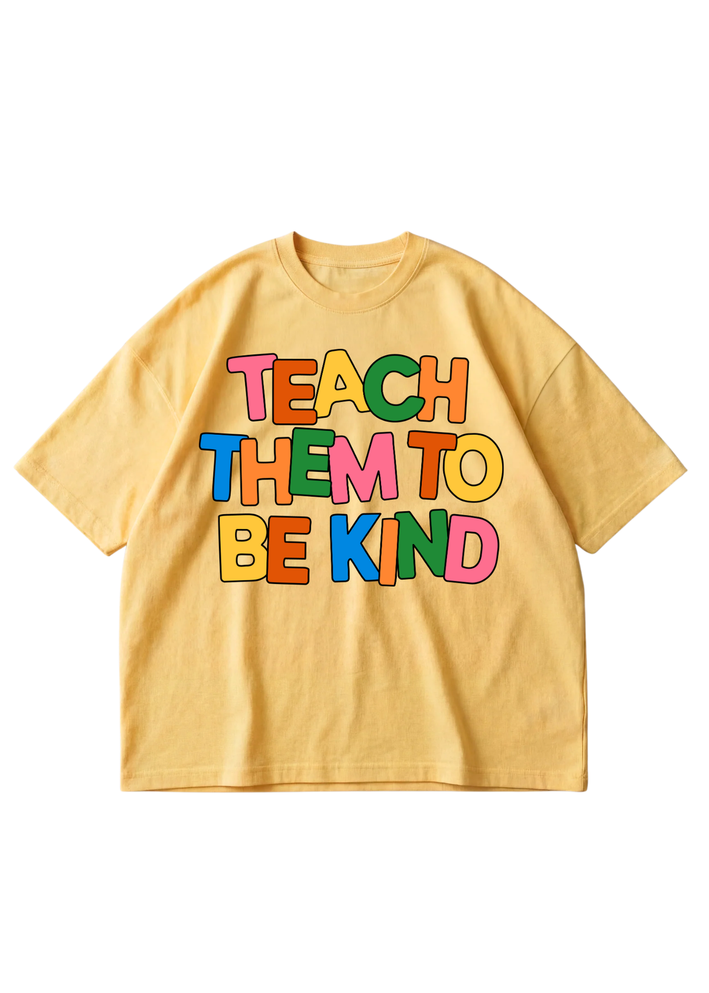 A yellow short-sleeve t-shirt with a colorful retro-style graphic on the front that reads 'TEACH THEM TO BE KIND' in multicolored letters, displayed flat against a white background