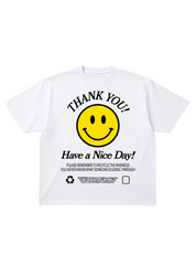 A white short-sleeve t-shirt featuring a yellow smiley face graphic with the text 'THANK YOU! Have a Nice Day!' and recycling instructions printed below, flat lay frontal view