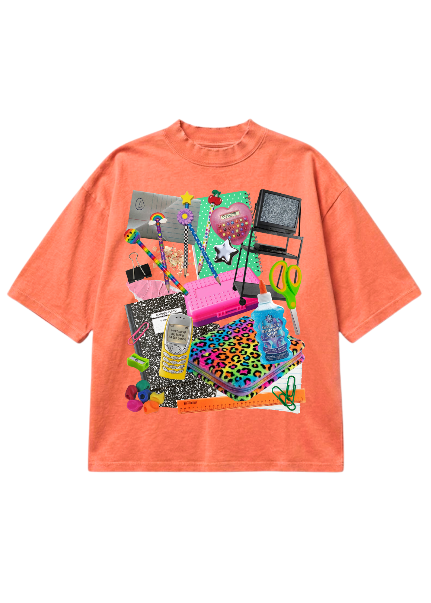 A coral orange short-sleeve t-shirt with a large, colorful graphic collage on the front featuring various fashion and beauty items like a pink laptop, leopard print notebook, makeup palettes, and a hairbrush