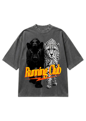 A dark gray mineral-wash t-shirt featuring a graphic print of a black panther and a cheetah, with the text 'Running Club' in yellow and orange across the front