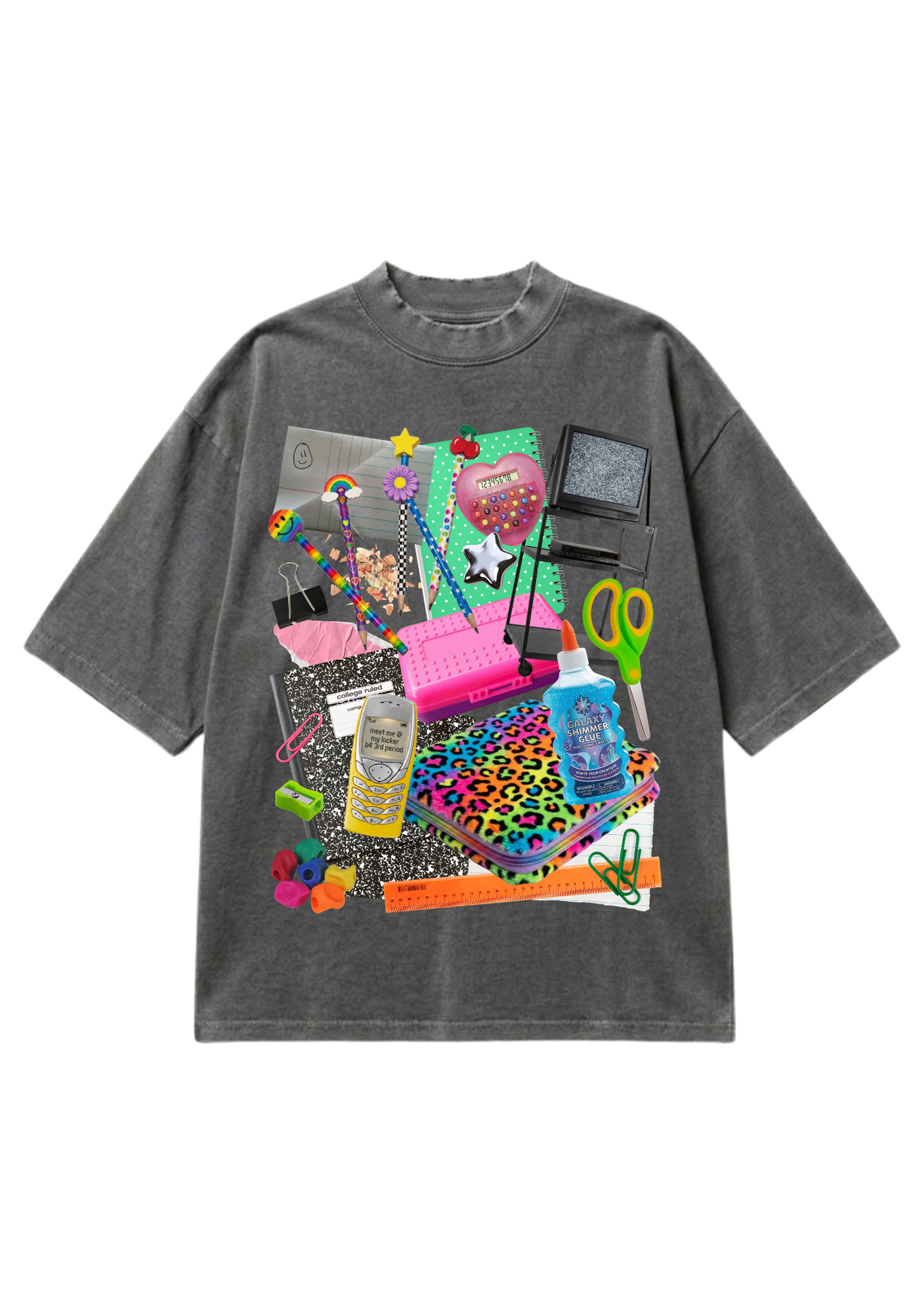 A dark gray mineral-wash t-shirt featuring a large, vibrant collage graphic on the front with various colorful objects like a pink keyboard, leopard-print notebook, retro TV, and scissors