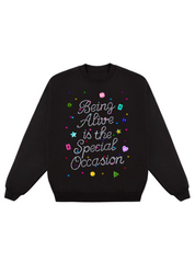 Black sweatshirt with colorful text 'Being Alive is the Special Occasion' design on a white background, flat lay frontal view