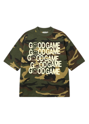 A short-sleeve crewneck t-shirt in a green camouflage pattern, featuring the text 'GOOD GAME' repeated vertically on the front in white, with some letters replaced by smiley faces