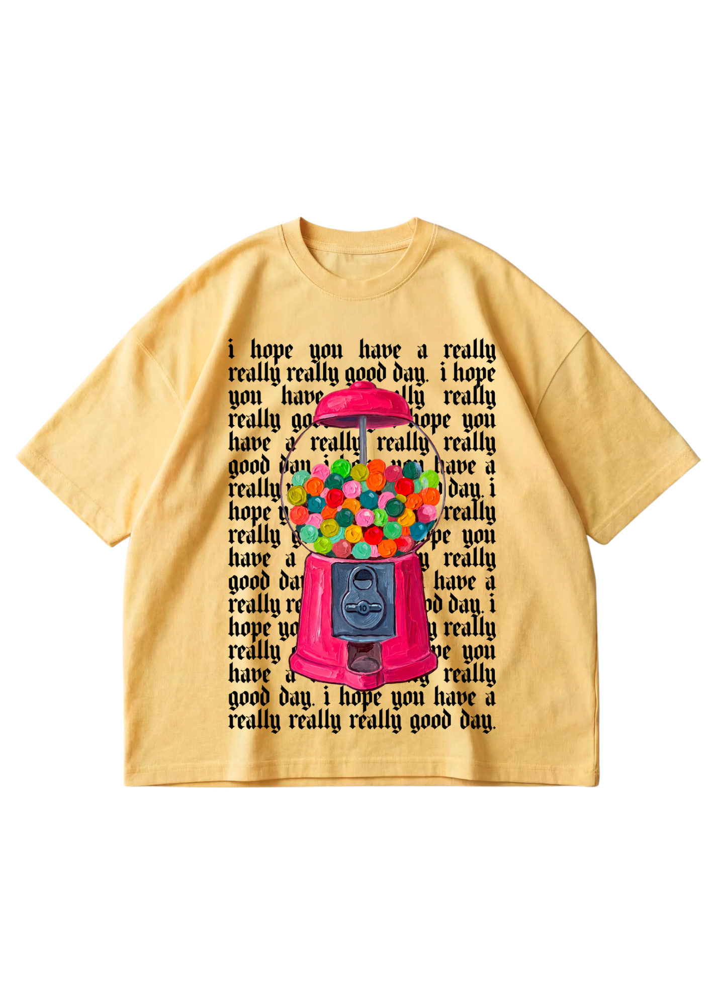 A yellow tee with a graphic of gumball machine and repeating text in the background that reads 'I hope you have a really, really good day' in black on a white background