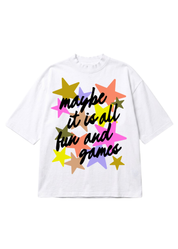 A white short-sleeve t-shirt with a colorful graphic print featuring the phrase 'maybe it is all fun and games' in black script over a cluster of multi-colored stars.