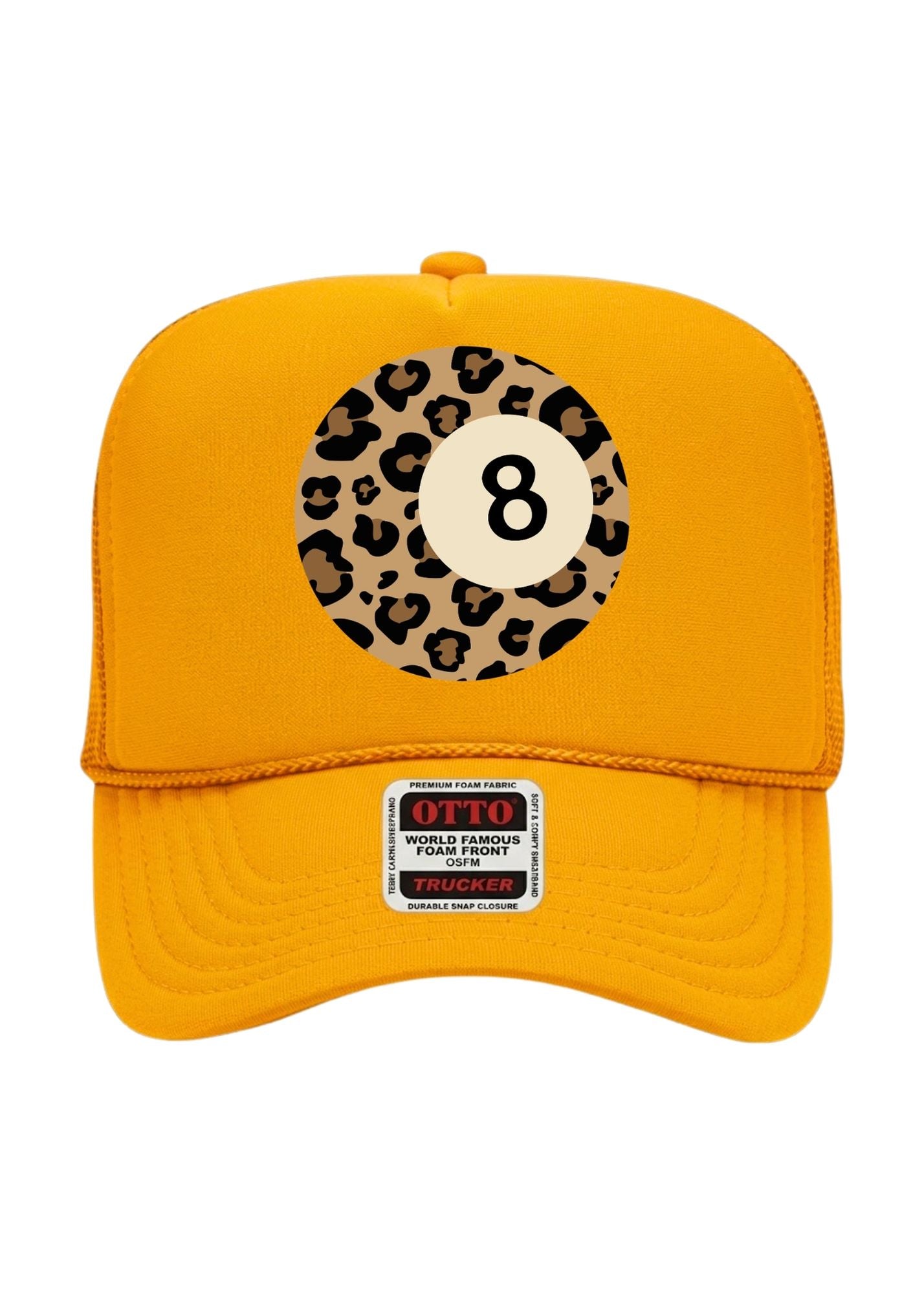 A bright yellow trucker-style baseball cap featuring a circular 8-ball graphic on the front with a leopard print border. A 'OTTO World Famous Force Pull Trucker' patch is visible on the brim.